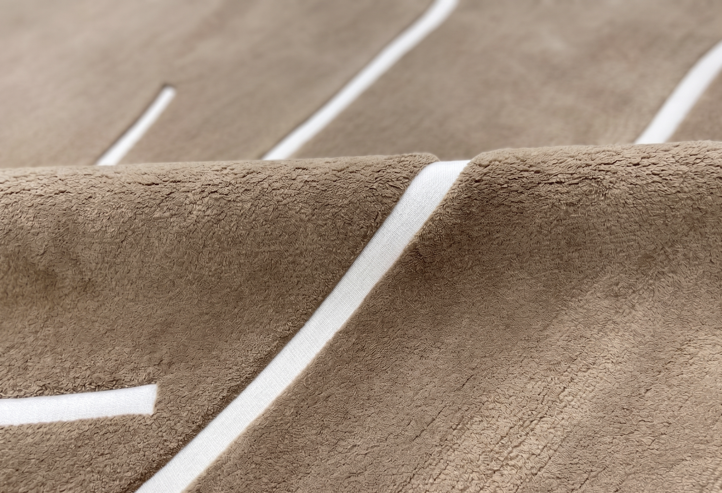 Hand-knotted rug detail — chocolate pile with ivory line work