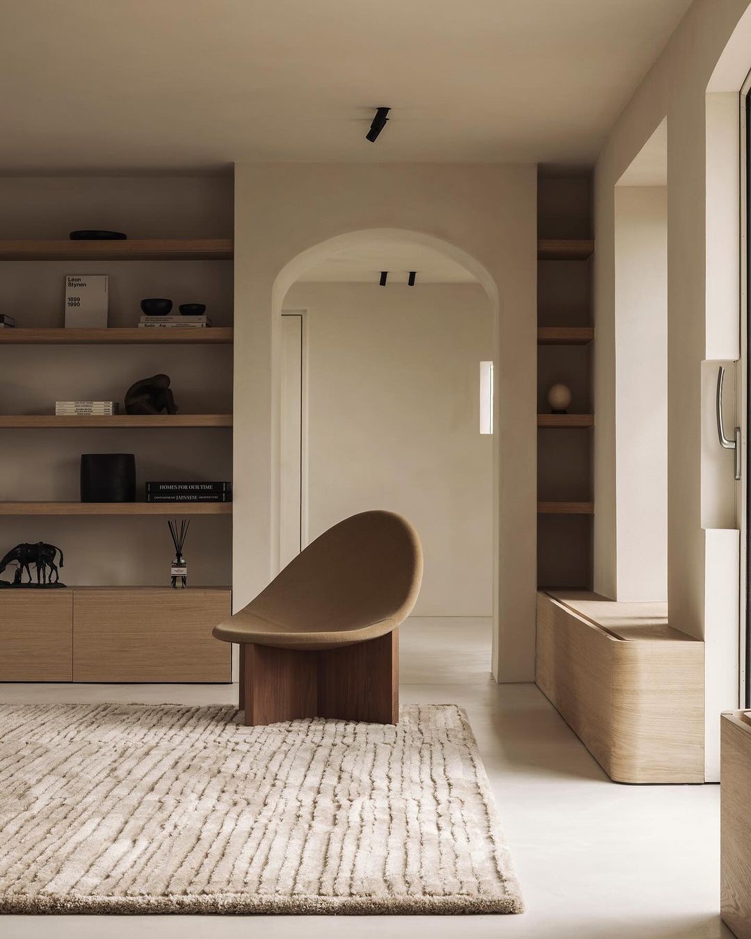 Hand-knotted ivory rug grounding a serene minimalist interior